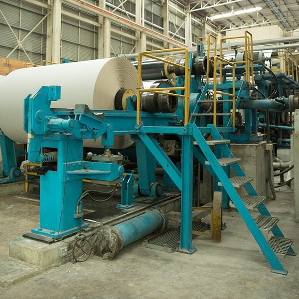 Large white paper reel on a paper-making machine